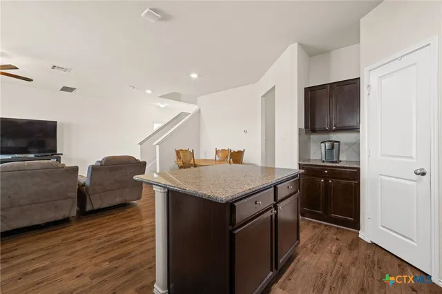 a kitchen with a stove and a refrigerator