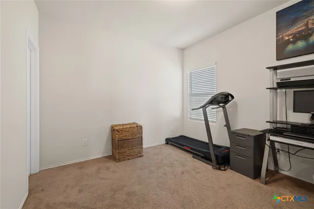 a room with gym equipment and a flat screen tv