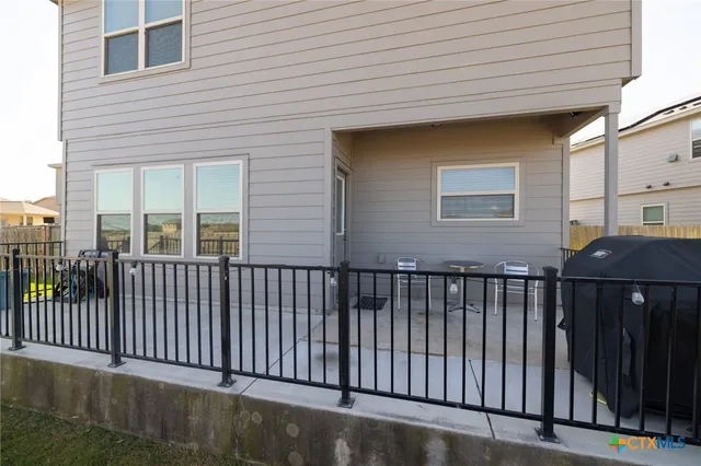 a view of a house with a wooden fence