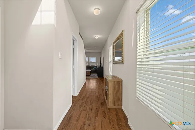a view of hallway with wooden floor