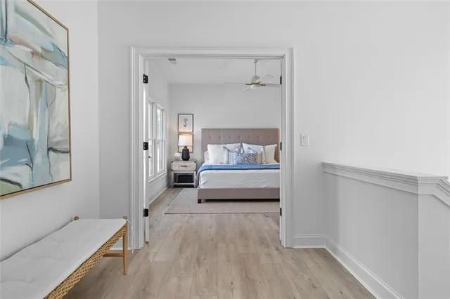 a bed sitting in a bedroom next to a window