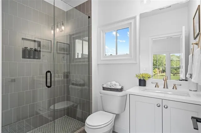 a bathroom with a shower sink and mirror