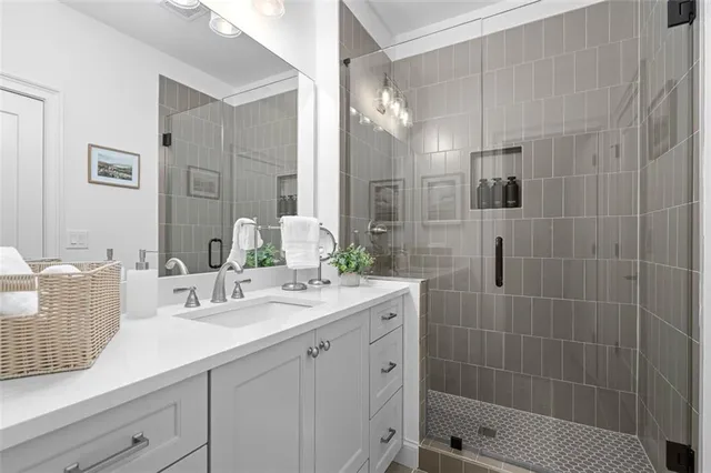 a bathroom with a sink a toilet a mirror and shower curtain