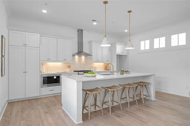 a kitchen with a table chairs stove and wooden floor