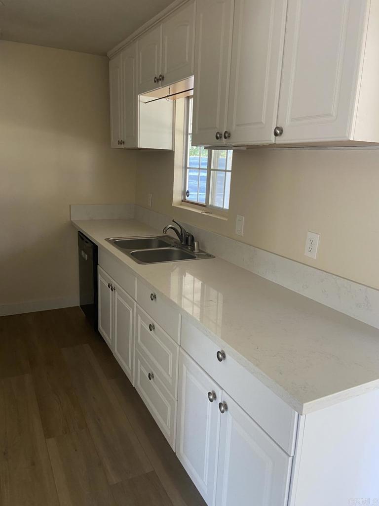917 Broadview Street Spring Valley, CA 91977 - Photo 5 of 14 a kitchen with granite countertop white cabinets and a stove