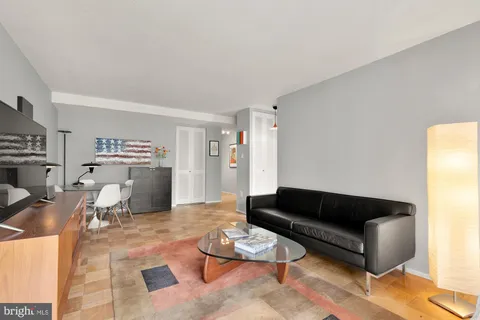 a living room with furniture a wooden floor and a window