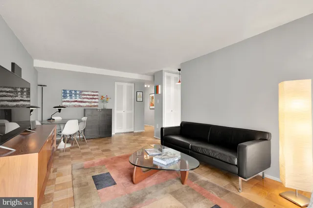 a living room with furniture a wooden floor and a window