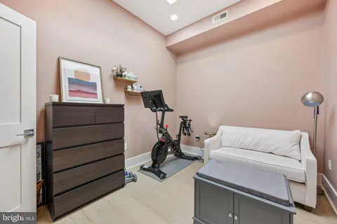 a living room with furniture and gym equipment