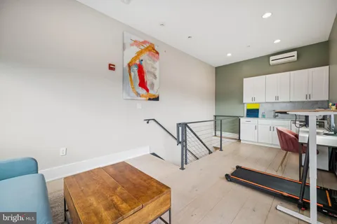 a view of a kitchen with stainless steel appliances cabinets