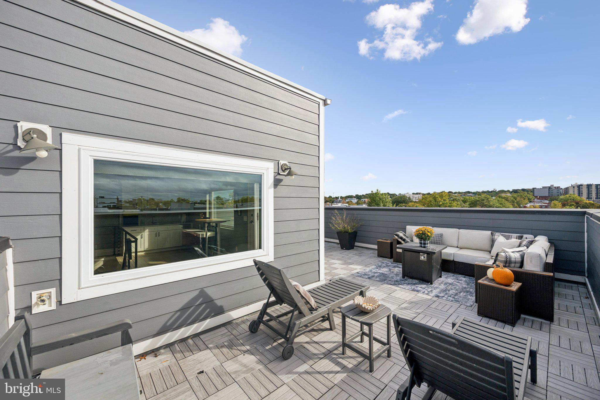 1316 Shepherd Street Northwest, Unit 4 Washington, DC 20011 - Photo 23 of 25 a roof deck with table and chairs