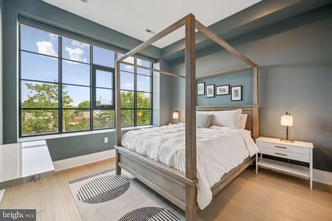 a bedroom with a large bed and a large window