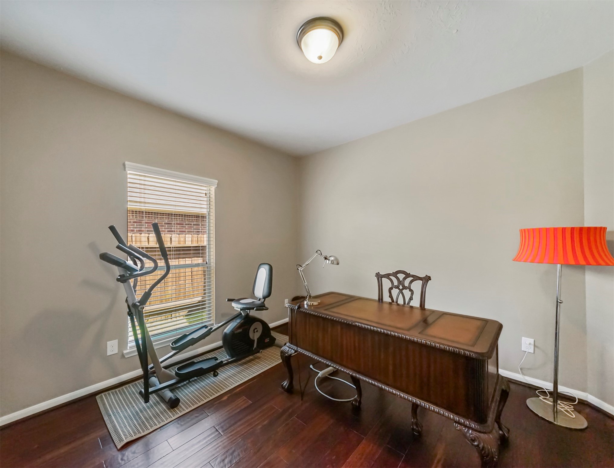 8214 Garrison Point Drive Houston, TX 77040 - Photo 13 of 37 a room with gym equipment on wooden floor