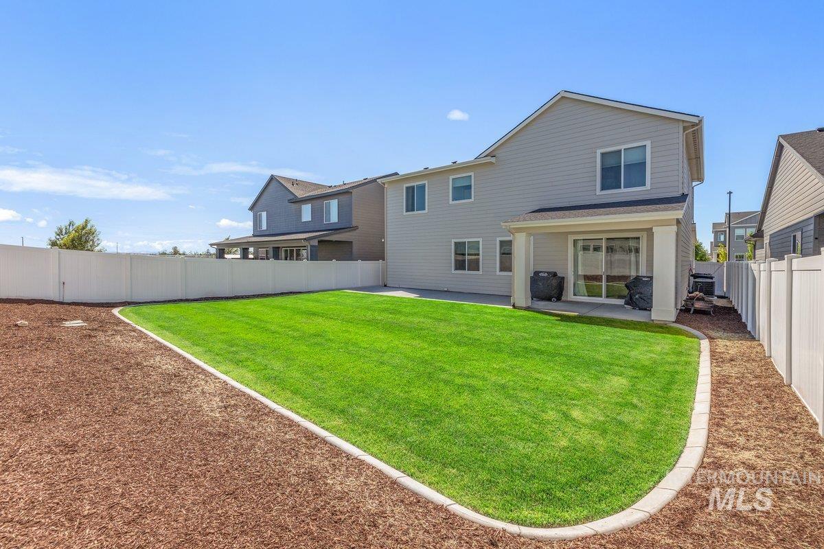 1380 West Chilitna Street Meridian, ID 83642 - Photo 43 of 50 Expansive backyard featuring a manicured lawn, a covered patio, and a privacy fence