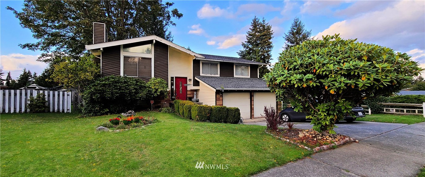 2304 Southeast 21st Street Renton, WA 98055 - Photo 1 of 19 a front view of a house with a yard and garage