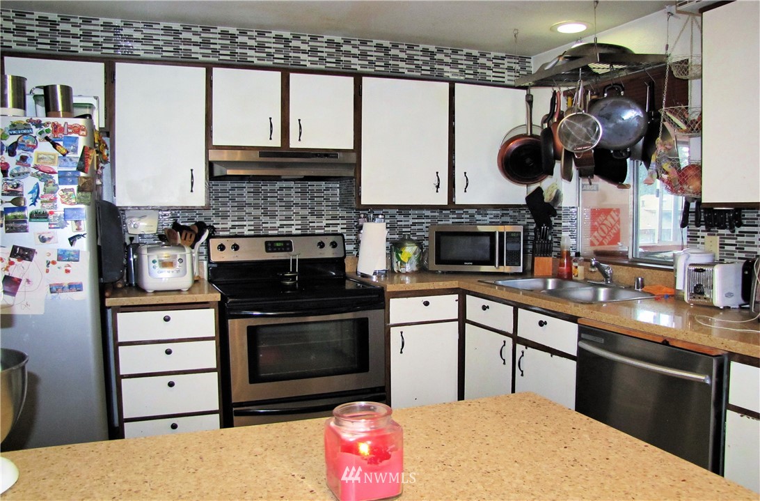 2304 Southeast 21st Street Renton, WA 98055 - Photo 13 of 19 a kitchen with stainless steel appliances granite countertop a stove and a sink