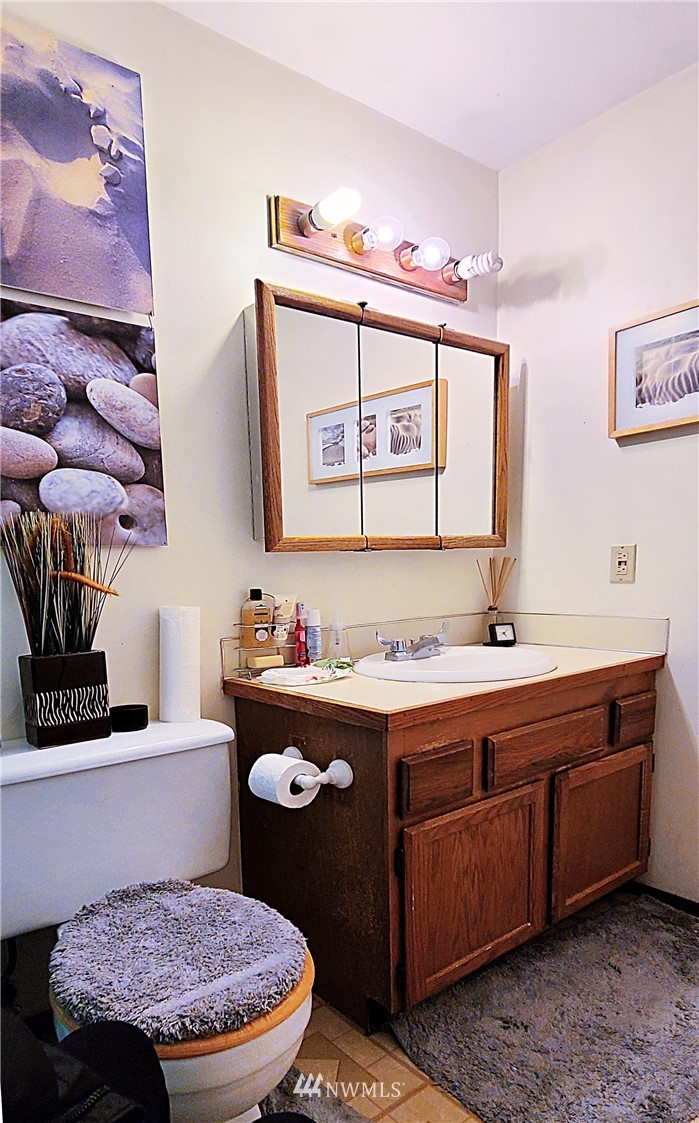 2304 Southeast 21st Street Renton, WA 98055 - Photo 15 of 19 a bathroom with a granite countertop toilet sink and mirror