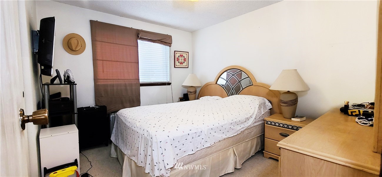 2304 Southeast 21st Street Renton, WA 98055 - Photo 16 of 19 a bed room with a bed and a table