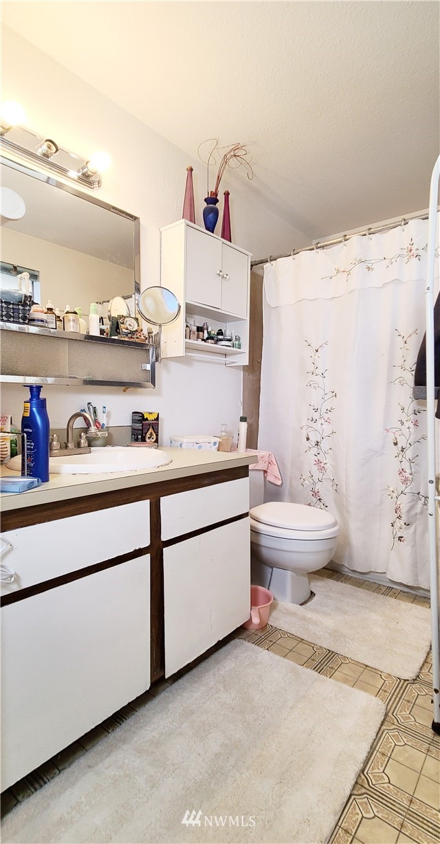 2304 Southeast 21st Street Renton, WA 98055 - Photo 19 of 19 a bathroom with a sink toilet and vanity
