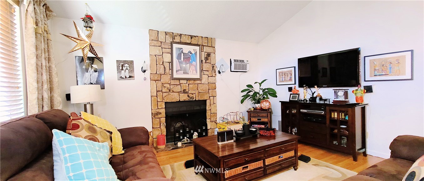 2304 Southeast 21st Street Renton, WA 98055 - Photo 8 of 19 a living room with furniture a flat screen tv and a fireplace
