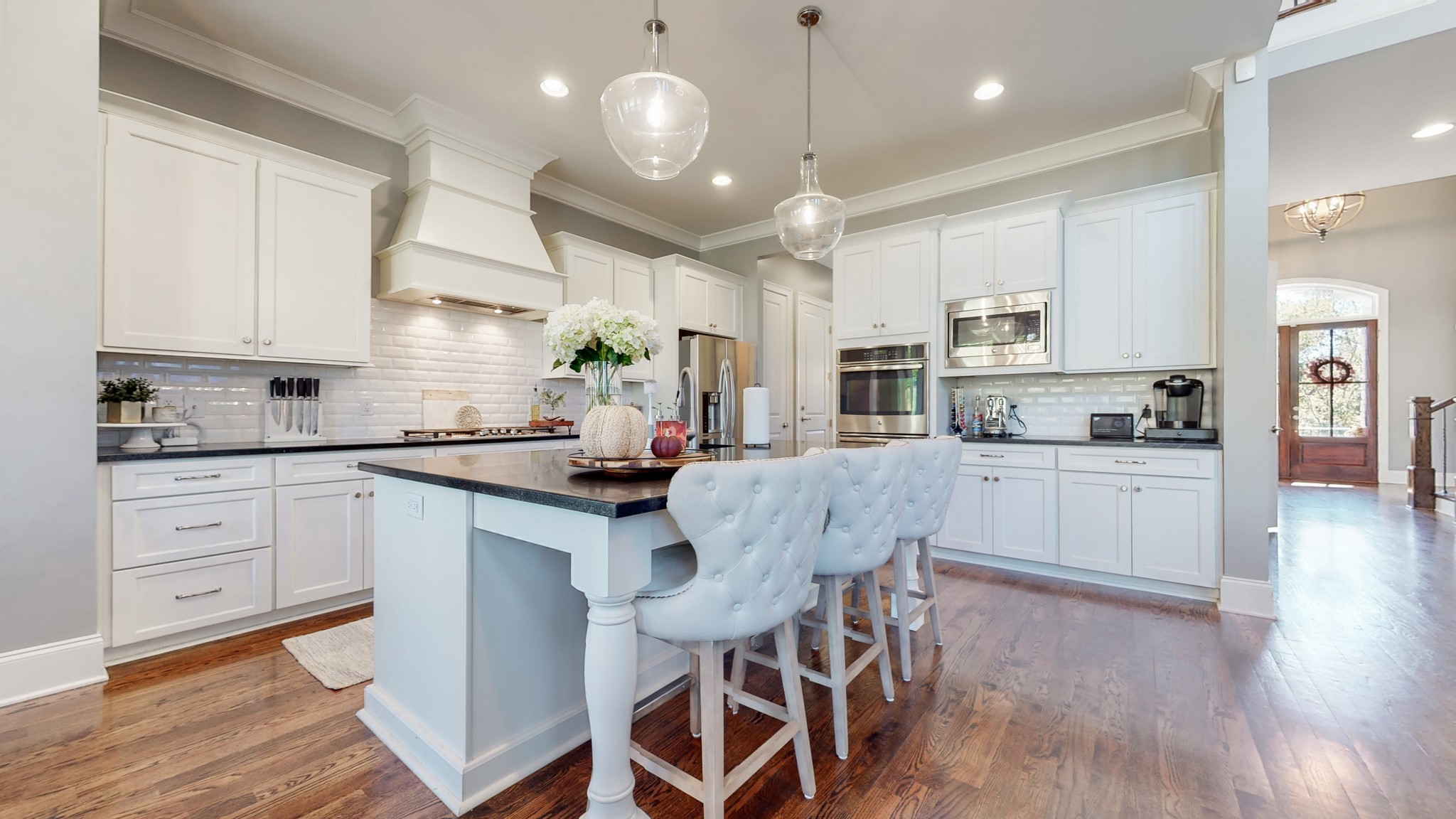 6023 Lookaway Circle Franklin, TN 37067 - Photo 19 of 50 a kitchen with stainless steel appliances kitchen island granite countertop a wooden floor and white cabinets