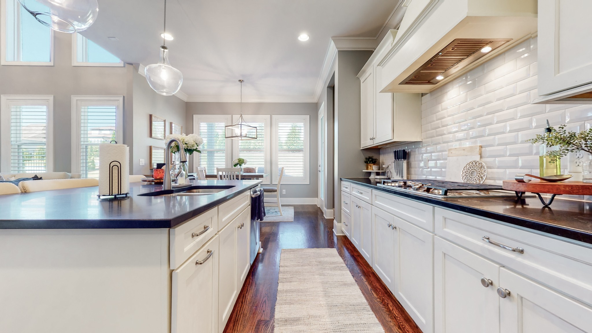 6023 Lookaway Circle Franklin, TN 37067 - Photo 21 of 50 a kitchen with kitchen island granite countertop a sink and white cabinets
