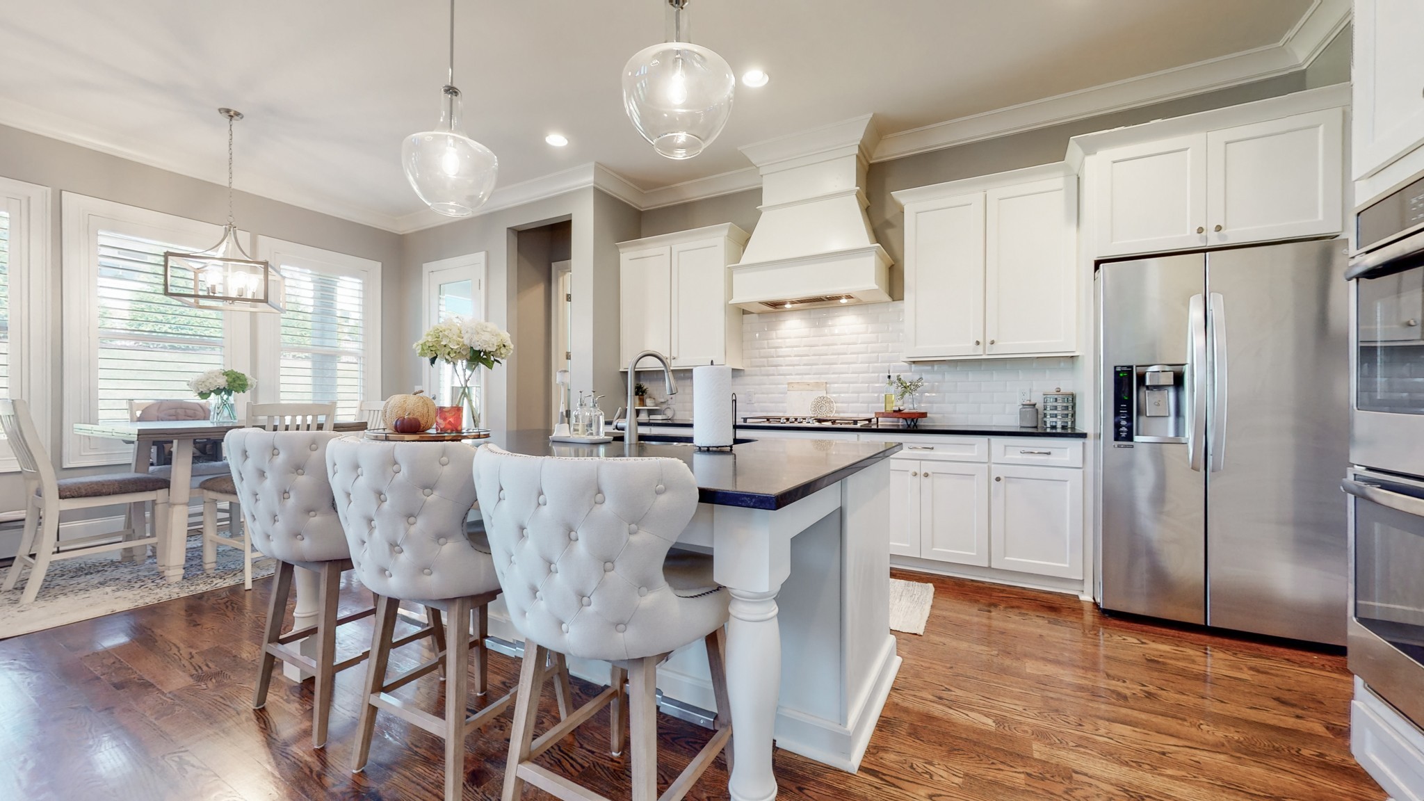 6023 Lookaway Circle Franklin, TN 37067 - Photo 22 of 50 a kitchen with stainless steel appliances granite countertop a dining table chairs refrigerator and sink