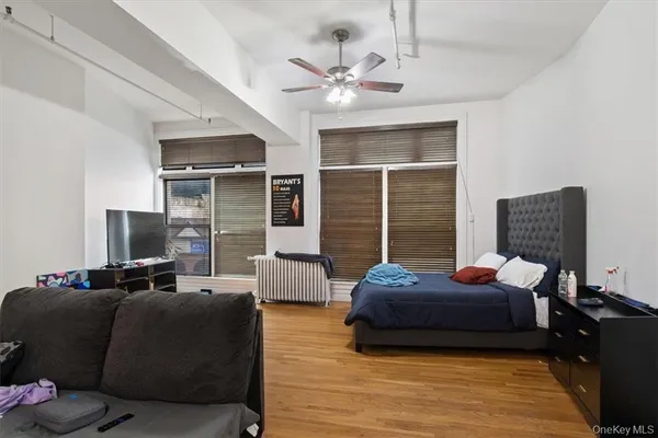 a bedroom with furniture and wooden floor