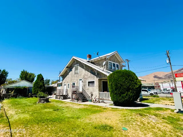 a view of a house with backyard and sitting area