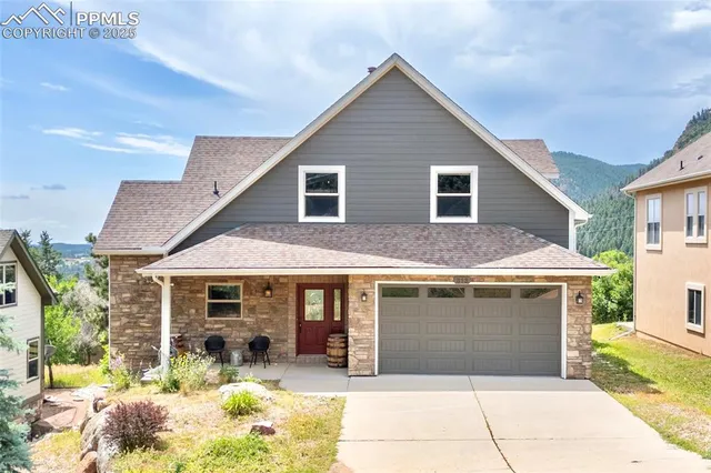 a front view of a house with a yard and garage
