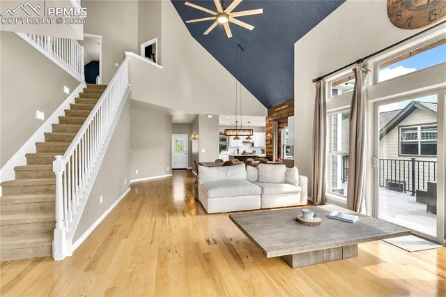 a view of living room kitchen with furniture and wooden floor