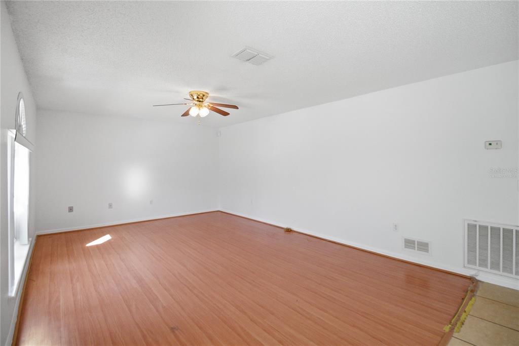 206 Taranto Way Kissimmee, FL 34758 - Photo 10 of 45 a view of an empty room and wooden floor