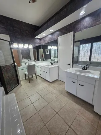 a kitchen with a sink cabinets and window