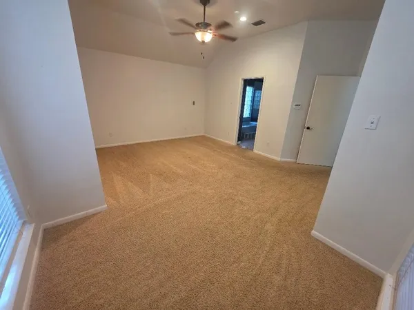 wooden floor in an empty room with a bathroom
