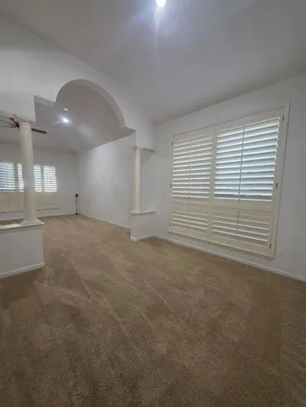an empty room with a empty space and windows