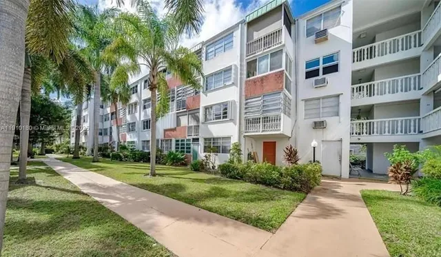 a view of a building with a yard