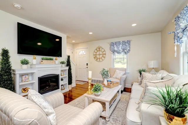a living room with furniture a fireplace and a flat screen tv