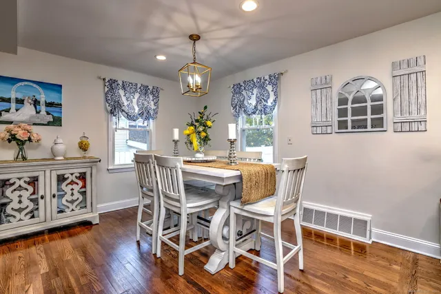 a view of a dining room with furniture wooden floor and chandelier