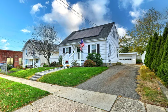 a front view of house with yard and green space
