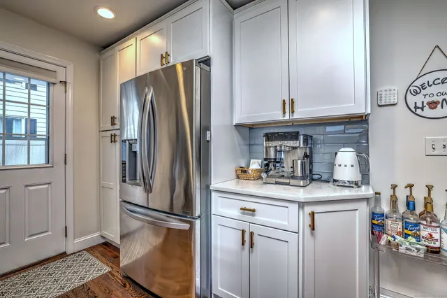 a kitchen with stainless steel appliances granite countertop a refrigerator and a sink
