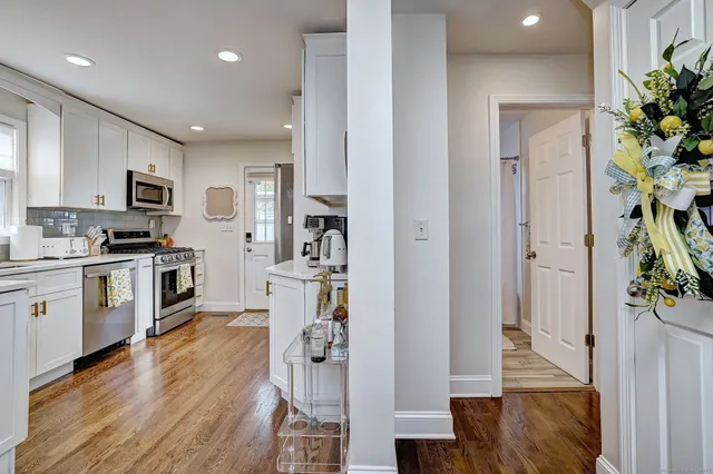 a kitchen with a refrigerator and a stove top oven