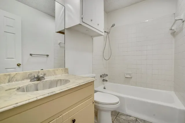 a bathroom with a sink a toilet and a bathtub