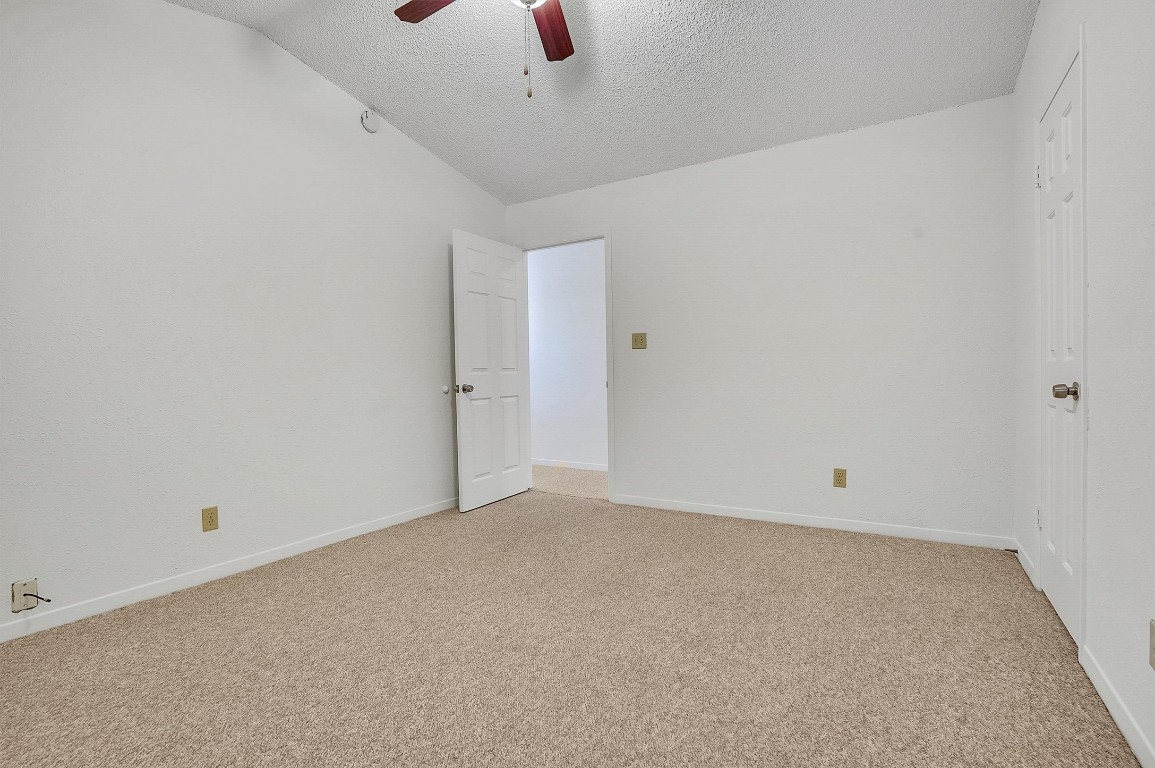 3201 Twinberry Cove, Unit B Austin, TX 78746 - Photo 16 of 19 an empty room with a ceiling fan and window