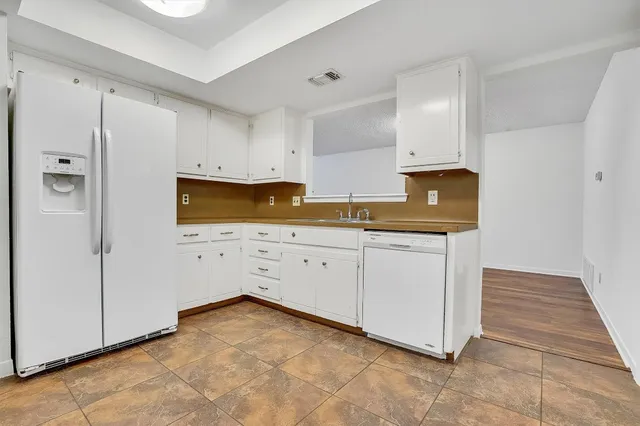 a view of kitchen with white cabinets