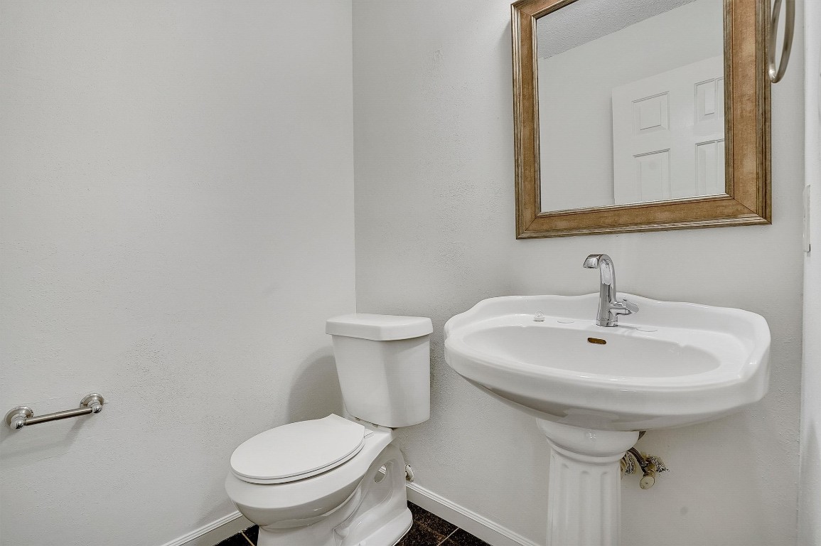 3201 Twinberry Cove, Unit B Austin, TX 78746 - Photo 10 of 19 a bathroom with a sink a toilet and mirror