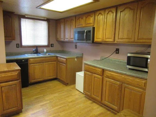 a kitchen with stainless steel appliances granite countertop a sink stove and microwave