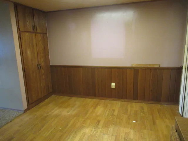 an empty room with wooden floor