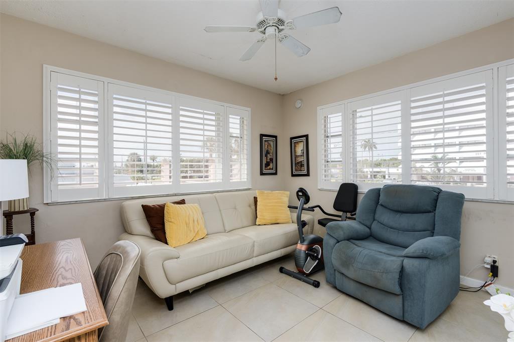 350 South Cypress Road, Unit 522 Pompano Beach, FL 33060 - Photo 12 of 27 a living room with furniture and a large window