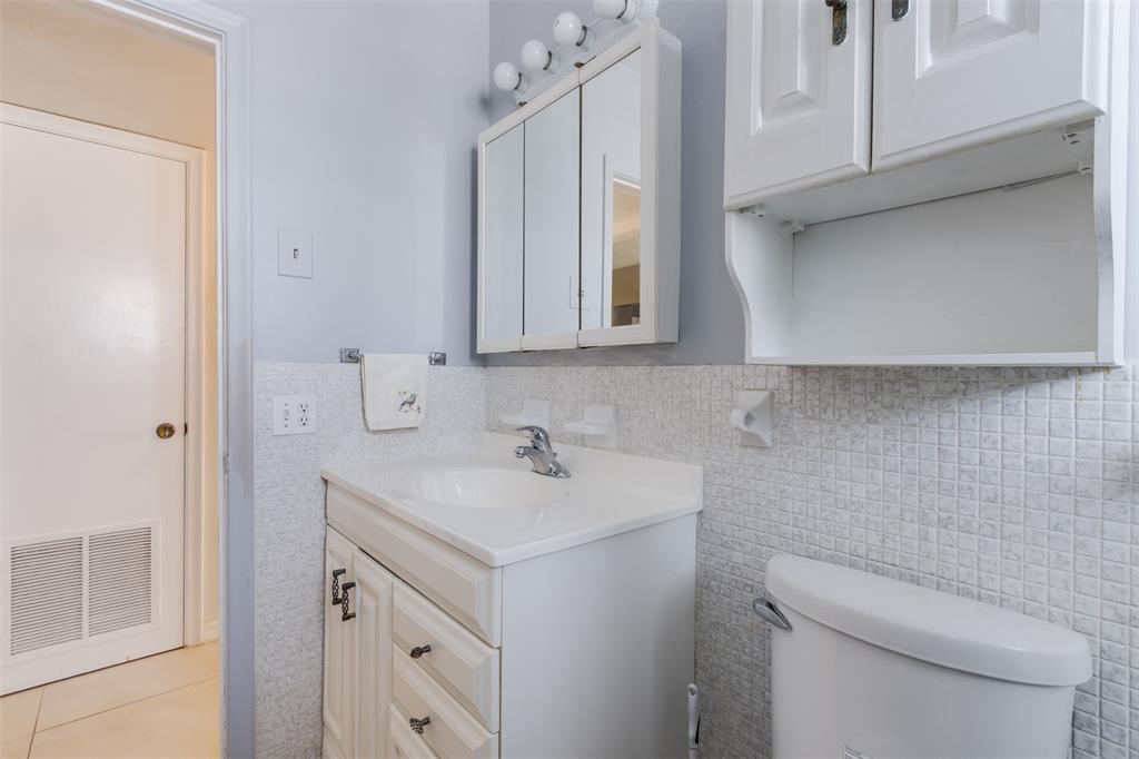 350 South Cypress Road, Unit 522 Pompano Beach, FL 33060 - Photo 17 of 27 a bathroom with a sink a toilet and vanity