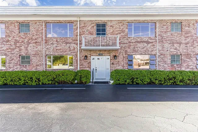 a view of front door of house with car parked