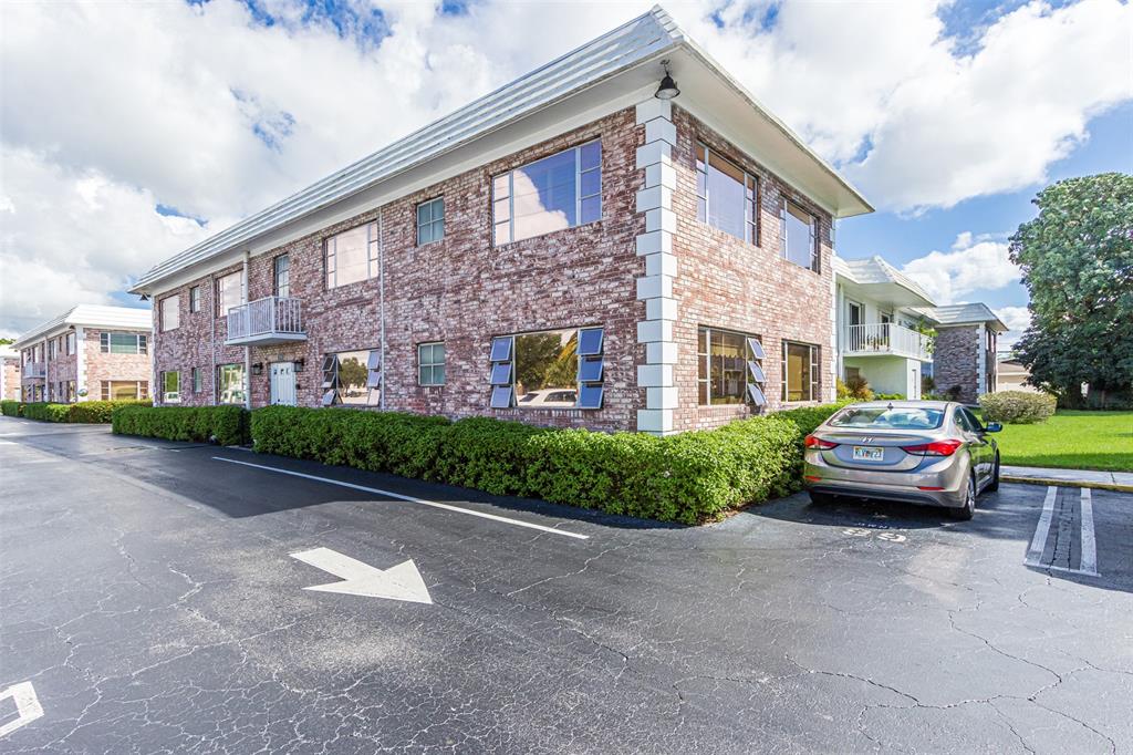 350 South Cypress Road, Unit 522 Pompano Beach, FL 33060 - Photo 21 of 27 a front view of a house with a garden